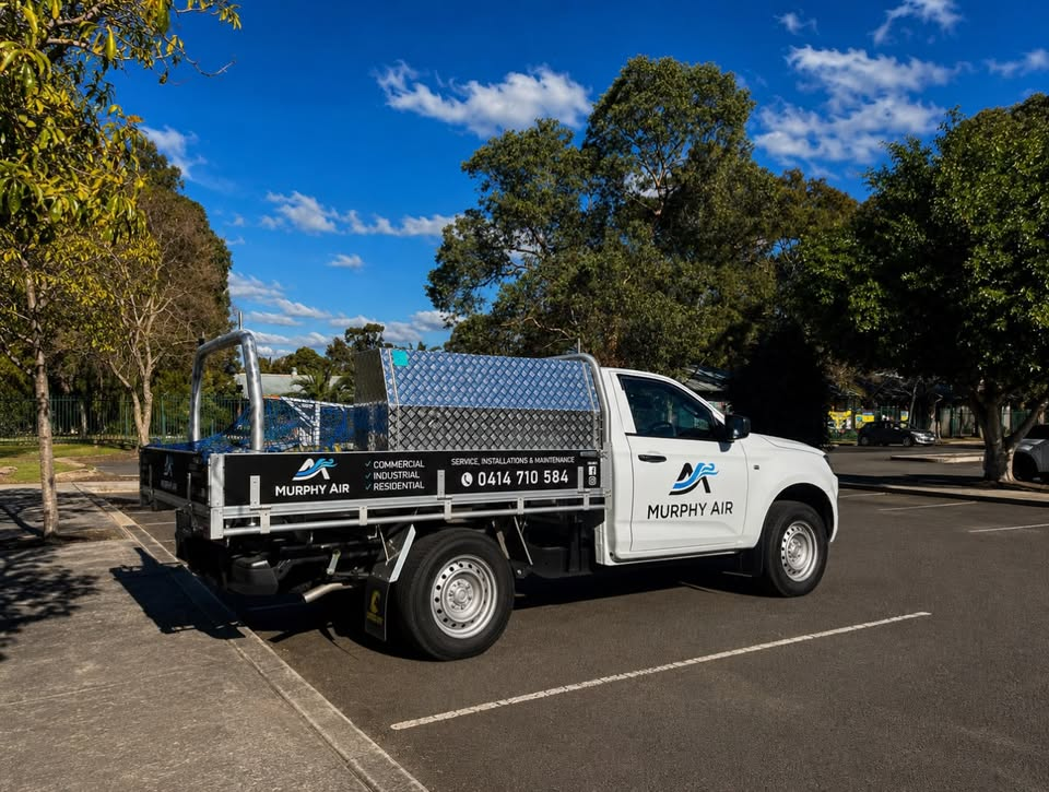 Murphy Air work ute with the company logo and phone number clearly displayed on the door and tray.